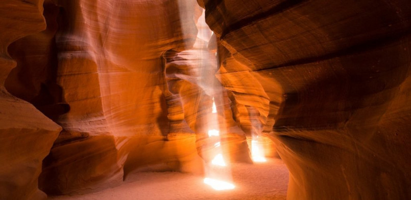 Antelope Canyon light beams Light beams streaming through narrow slot canyon walls