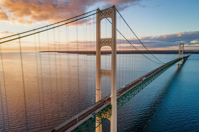 Mackinac Bridge Michigan sunset Mackinac Bridge spanning the Straits of Mackinac with sunset colors illuminating its suspension towers