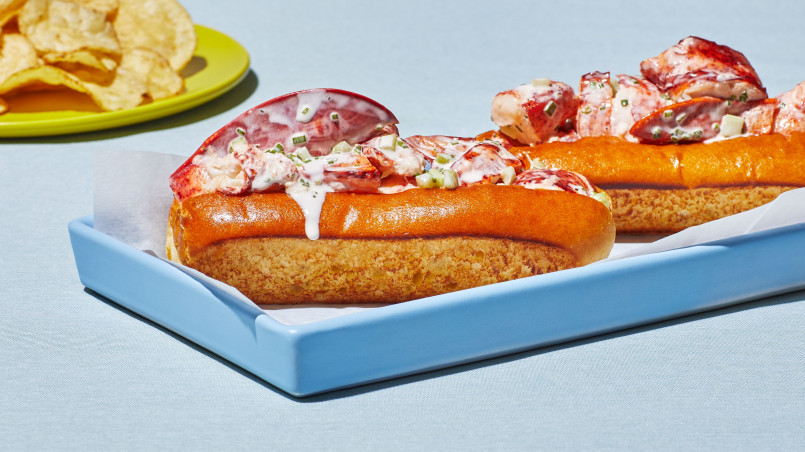 Lobster roll overflowing with chunks of lobster meat in a toasted split-top bun