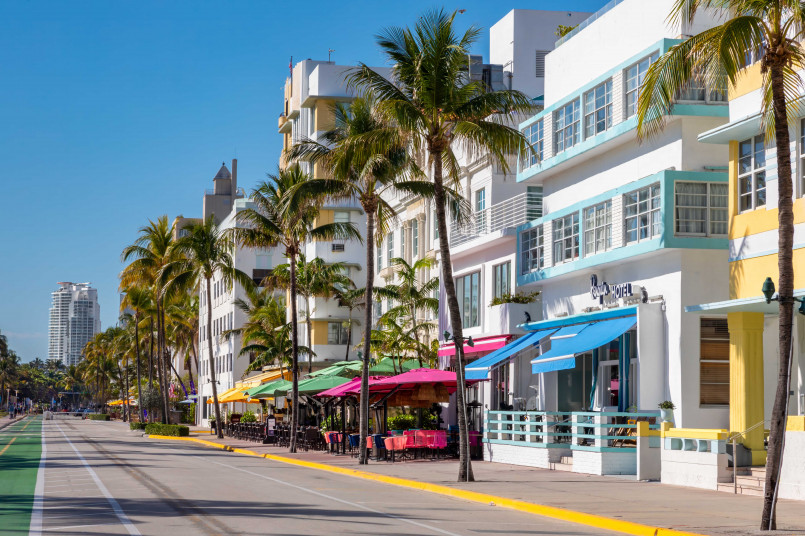 Colorful Art Deco hotels along Ocean Drive in Miami's South Beach with palm trees and vintage cars