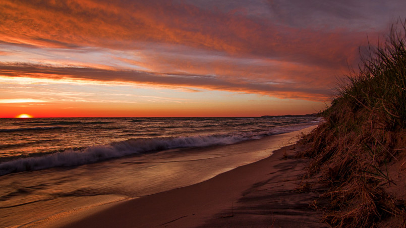Michigan lake sunset Sunset over a Michigan inland lake with dock and boats