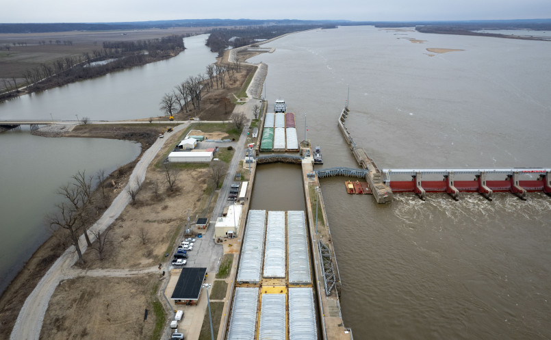 Mississippi River lock and dam system Large lock and dam complex on the Mississippi River with barges passing through the lock chamber