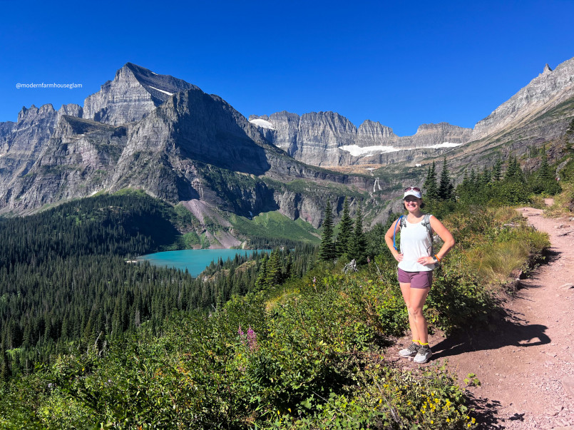Hikers on a trail in Glacier National Park with mountain and lake views