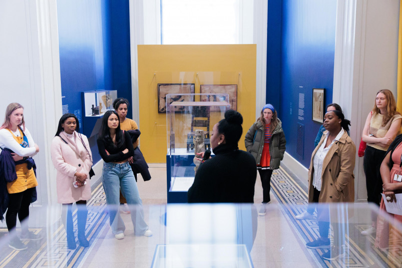 Museum visitors using digital guide Museum visitors using a mobile app guide while viewing exhibits