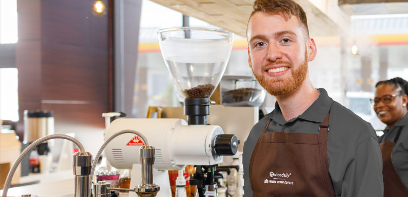 Nashville tennessee coffee shop, barista serving customers A warm, wood-filled Nashville coffee shop with guitar décor and customers being served at the counter