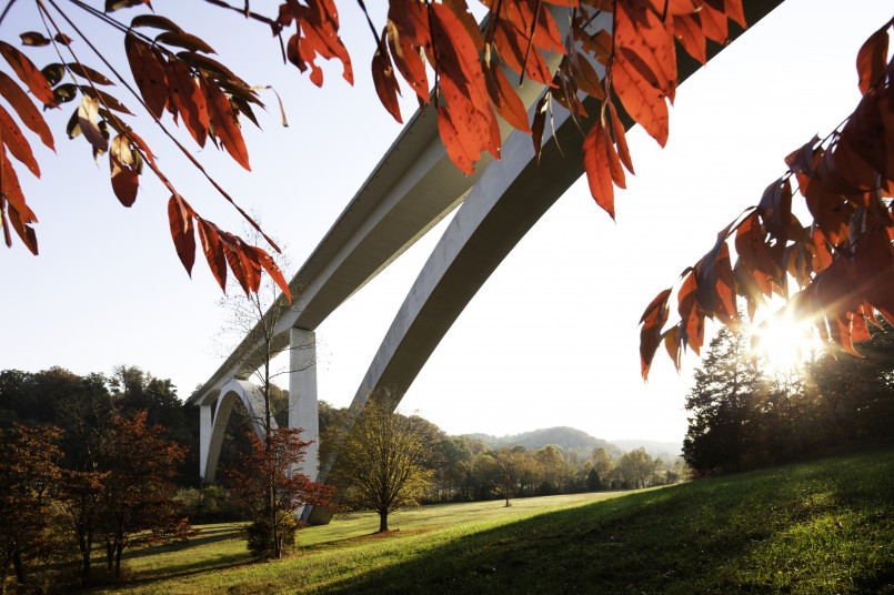 The double-arch Natchez Trace Parkway Bridge surrounded by green forest