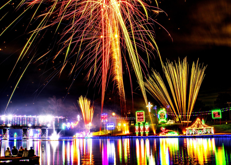 Historic brick buildings along Cane River illuminated with Christmas lights