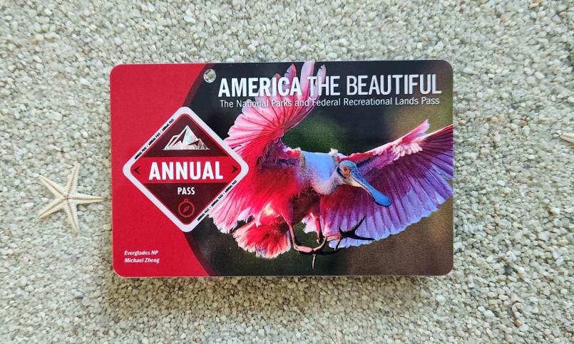 America the Beautiful annual national parks pass hanging from car rearview mirror