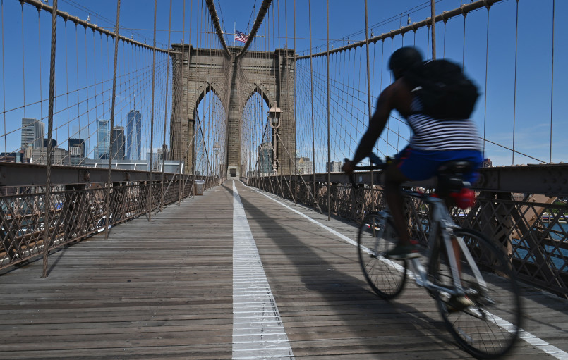 New York City cyclists Brooklyn Bridge Cyclists crossing the Brooklyn Bridge on a dedicated bike path with Manhattan skyline in background