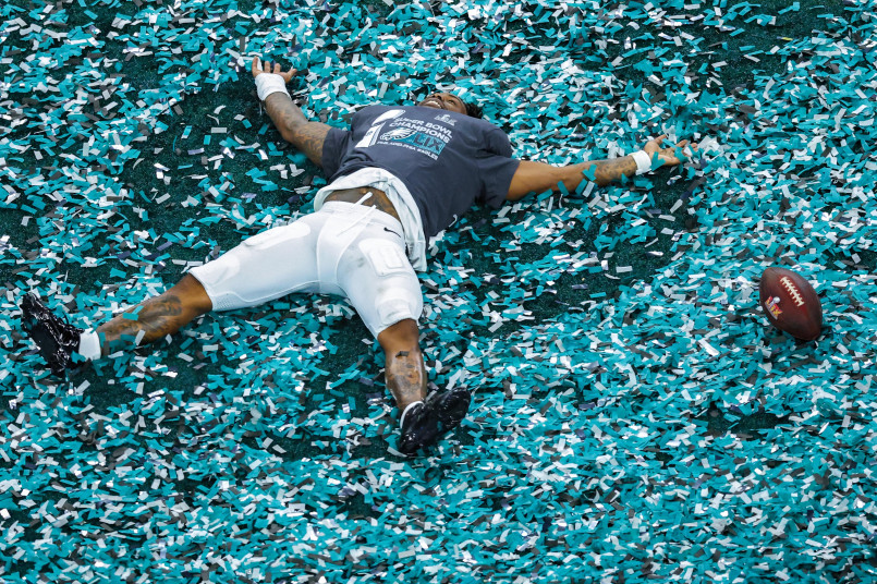 Super Bowl champions celebrating with confetti falling in a packed stadium