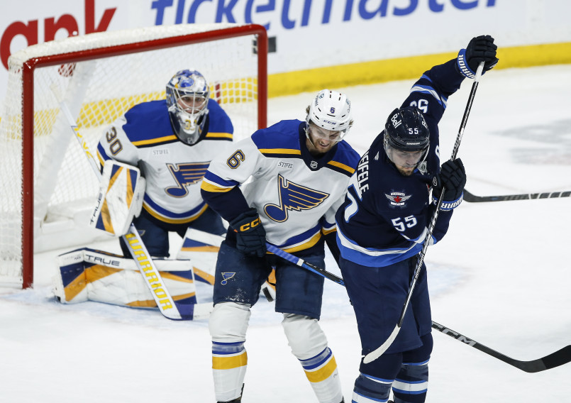 Ice hockey players battling for the puck during an intense NHL game