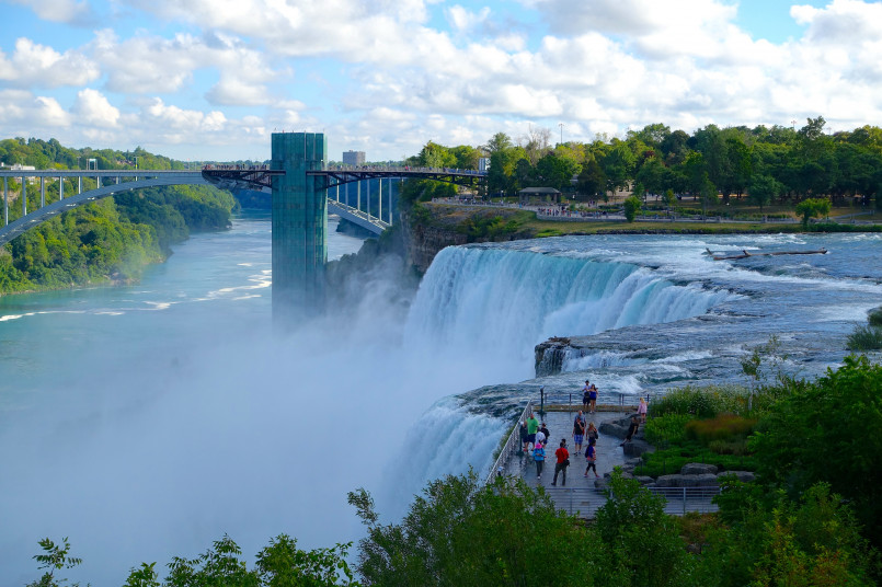 Rainbow forming in the mist of Niagara Falls viewed from the American observation deck