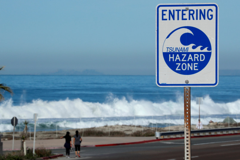 Oregon coast tsunami hazard zone sign Tsunami hazard zone evacuation route sign on the Oregon coast with ocean in background