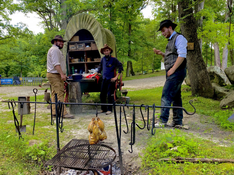 Pioneer family cooking dinner at a campsite along the Oregon Trail