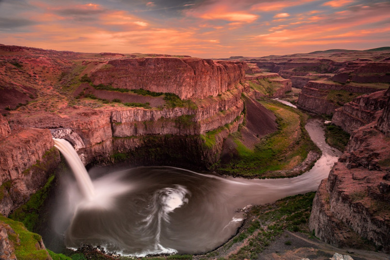 Palouse Falls plunging into circular canyon during golden hour