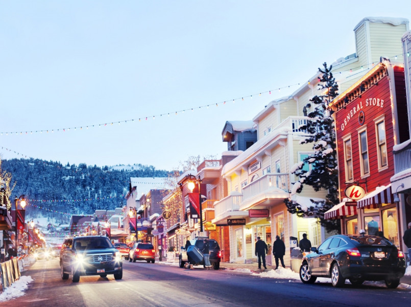 Park City Utah Christmas Main Street Historic Main Street in Park City with buildings decorated with Christmas lights and decorations with snow-covered mountains in background