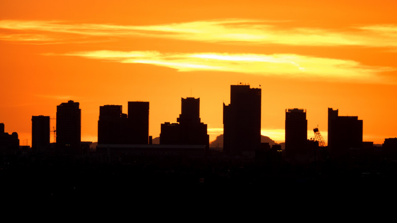 Phoenix, Arizona skyline at sunset showing downtown buildings and mountains in background