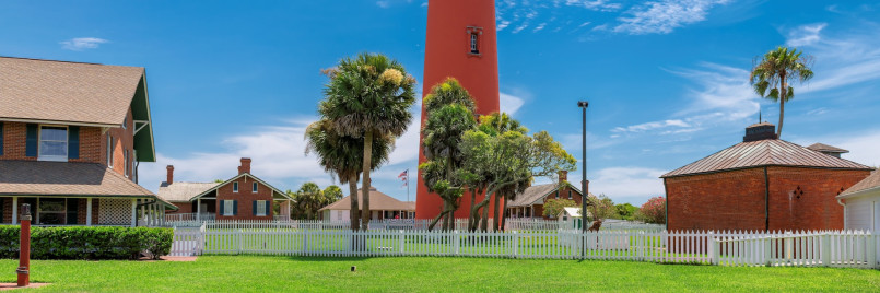 Ponce de Leon Inlet Lighthouse red brick tower Florida Tall red brick lighthouse tower with keeper's houses at base