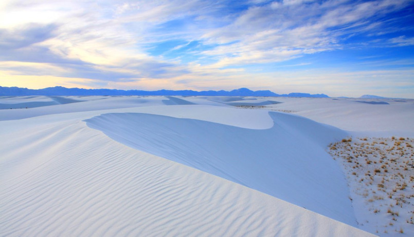Pristine white gypsum sand dunes stretching to the horizon at White Sands National Park