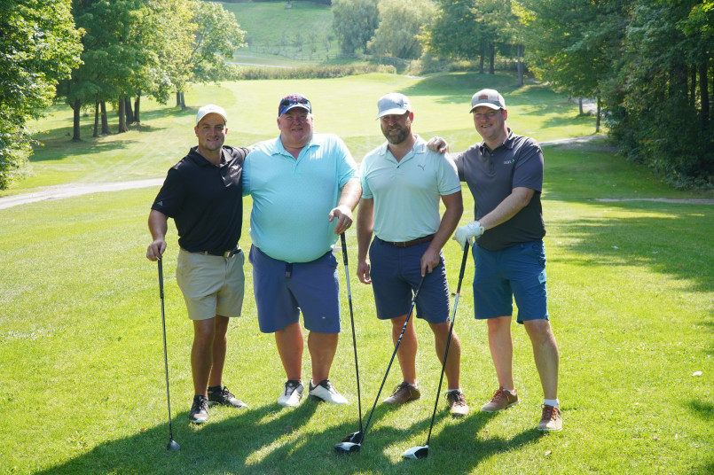 Large gallery of spectators following professional golfers at a major tournament