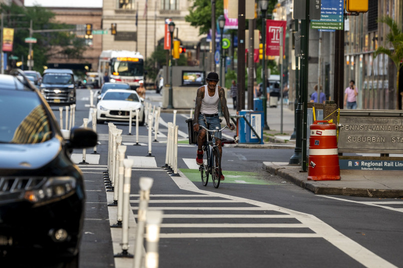 Protected bike lane with cyclists A protected bike lane separated from traffic with cyclists riding safely