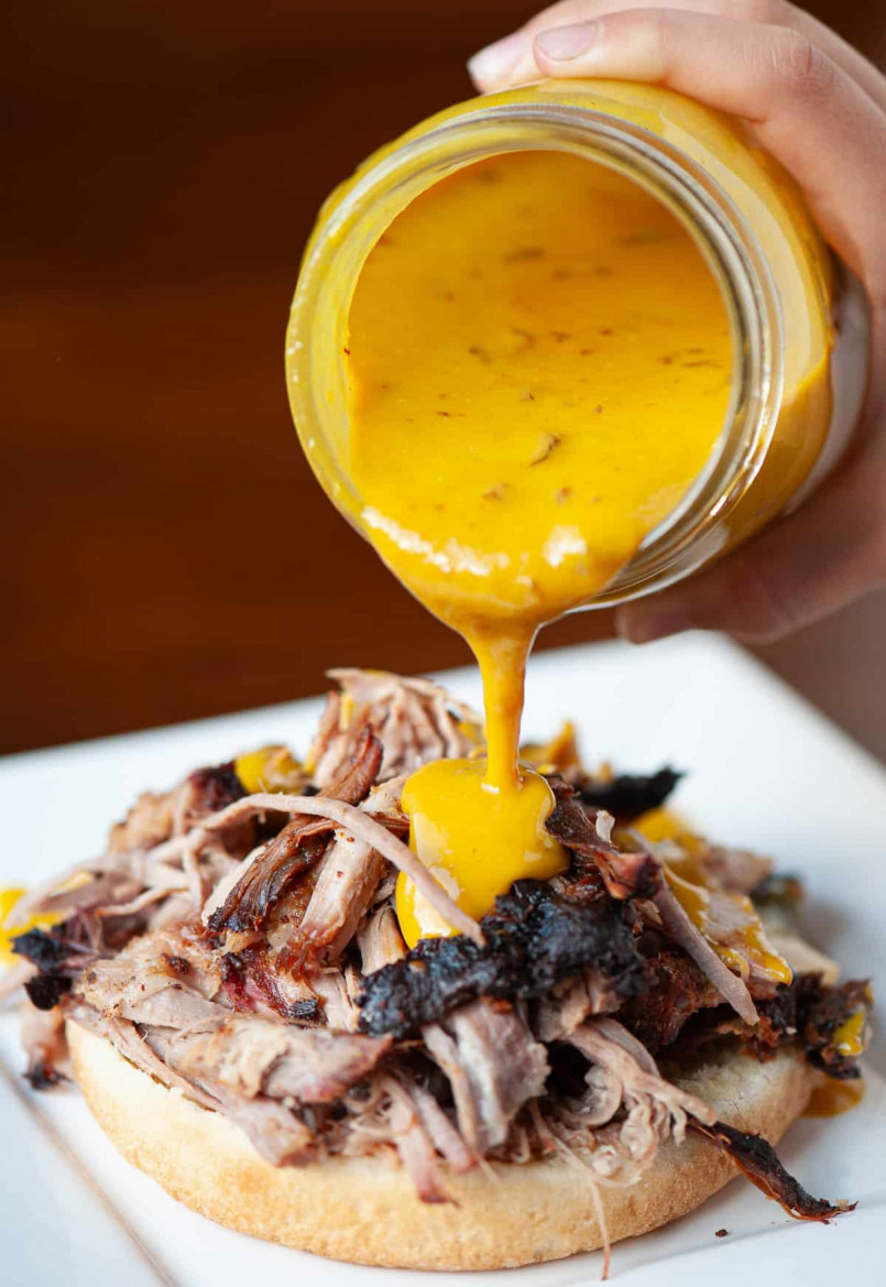 South carolina mustard bbq sauce pulled pork Pulled pork with golden mustard-based sauce on a sandwich with coleslaw