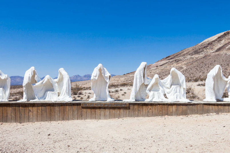 Rhyolite ghost town nevada Historic buildings and ruins in Rhyolite, Nevada with desert mountains in the background
