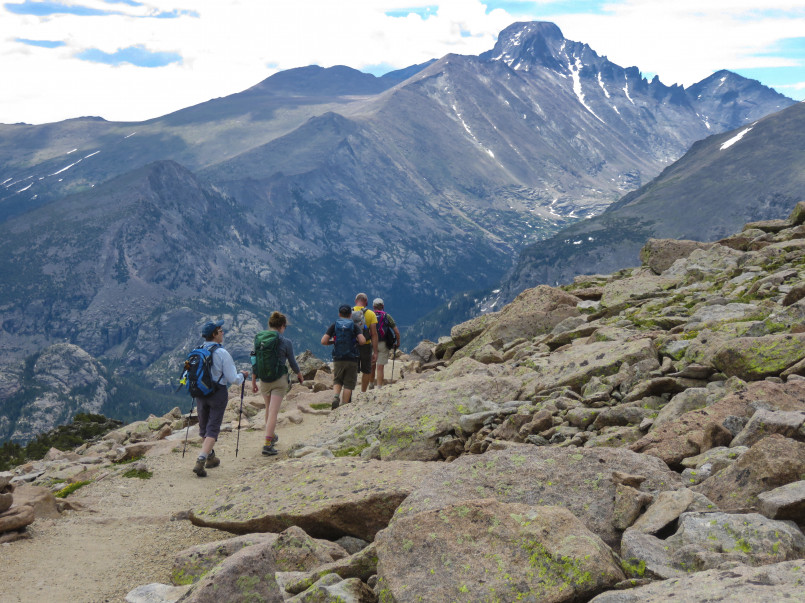 Rocky Mountain National Park alpine hiking trail Hikers on alpine trail with mountain views in Rocky Mountain National Park