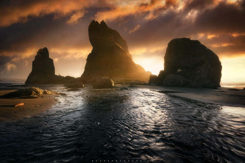 Misty view of dramatic sea stacks at Ruby Beach with driftwood in foreground