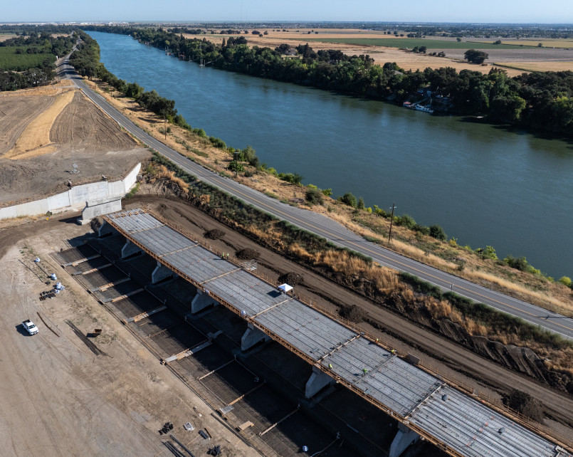 Sacramento river levee flood risk Sacramento River with aging levee system and city skyline in background