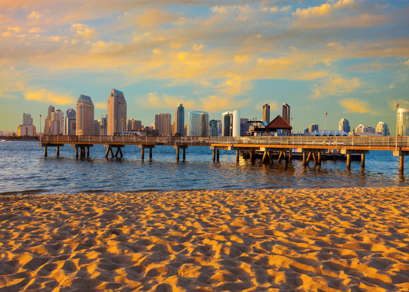 San Diego beach and skyline San Diego skyline with beach, palm trees and Coronado Bridge