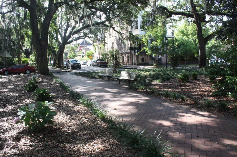 Tree-lined historic square in Savannah with Spanish moss and 19th century homes