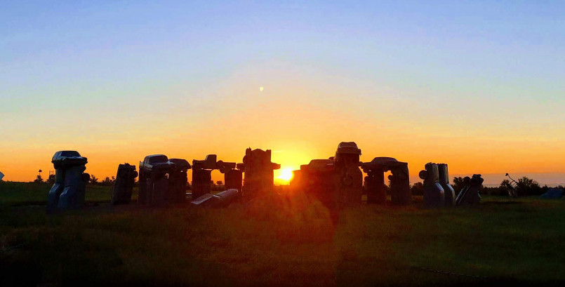 Silhouette of Carhenge in Alliance, Nebraska with a dramatic sunset in the background
