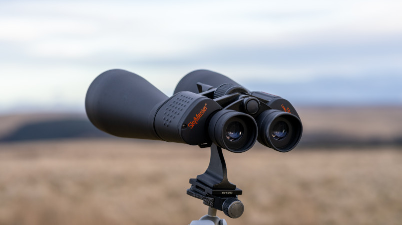 Essential stargazing equipment including telescope, binoculars, and star charts