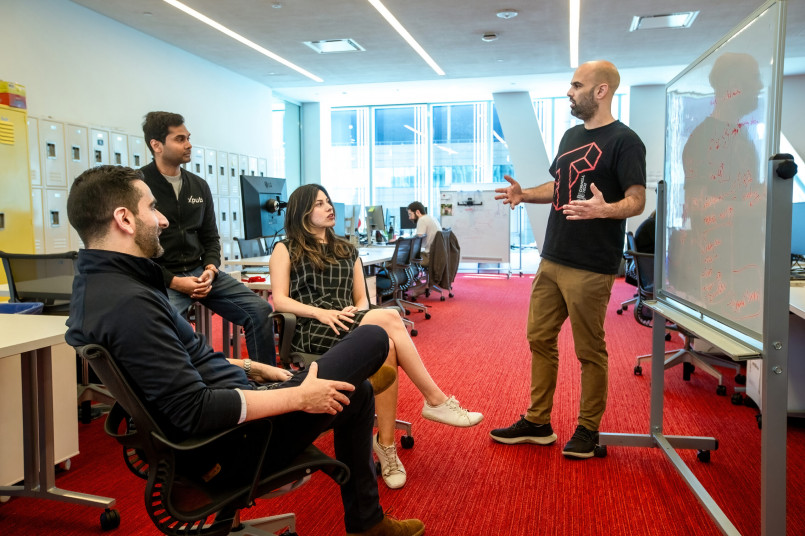 Tech startup office culture diverse team Diverse team of technology professionals collaborating in a modern office space