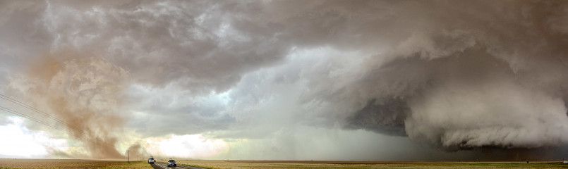 Texas tornado, supercell storm Large tornado touching down in rural Texas landscape with farm buildings in foreground