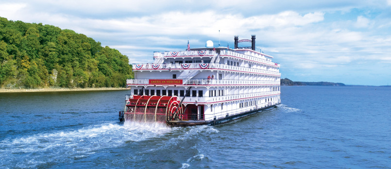 Tourist riverboat Mississippi River Modern passenger cruise ship navigating the Mississippi River with scenic bluffs and shoreline visible