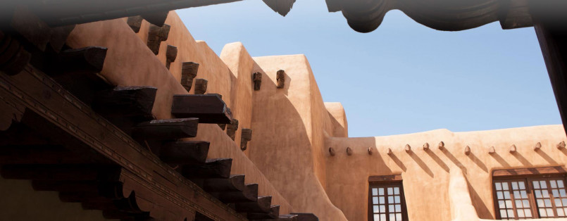Traditional adobe buildings with turquoise doors and windows in Santa Fe