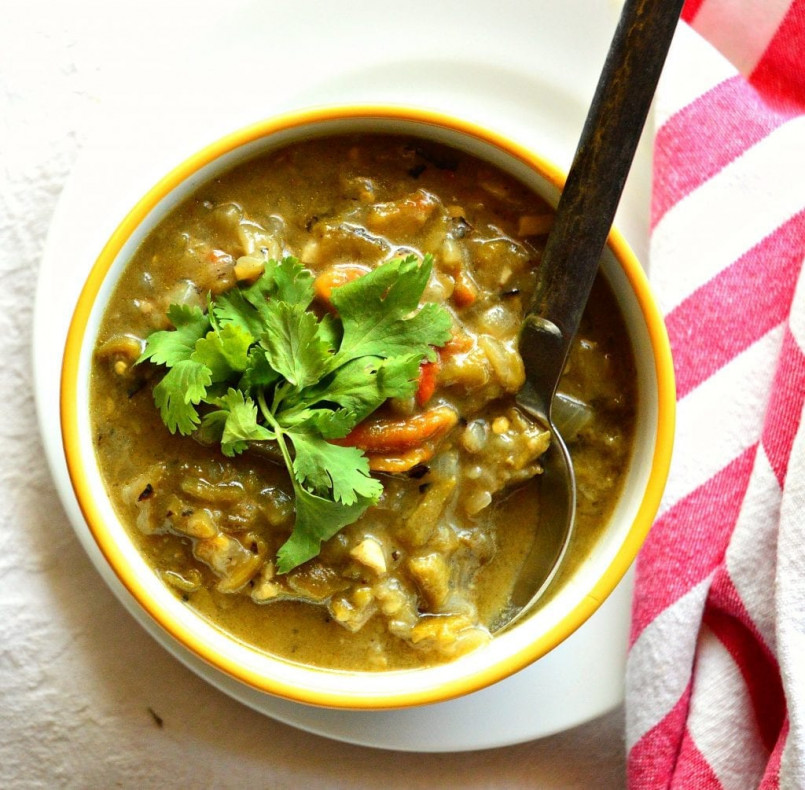 Traditional New Mexican dish featuring green chile sauce in a rustic Taos restaurant setting