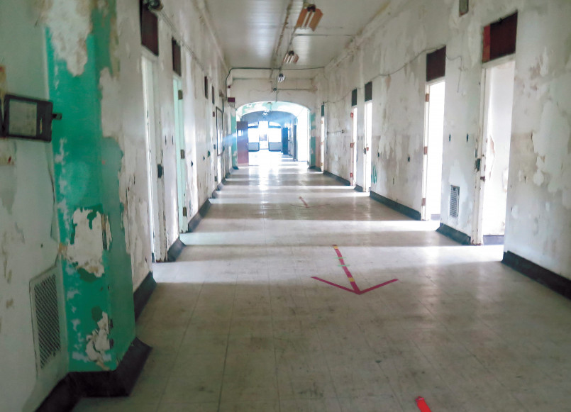 Trans-Allegheny Lunatic Asylum corridor Long, deteriorating corridor with peeling paint and abandoned medical equipment