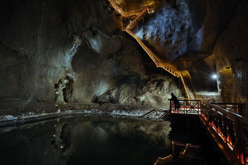 Massive white salt mine cavern with mining equipment on display
