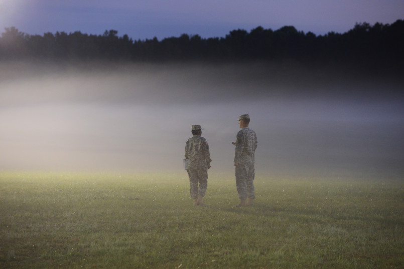 Military personnel interacting with local community members near base