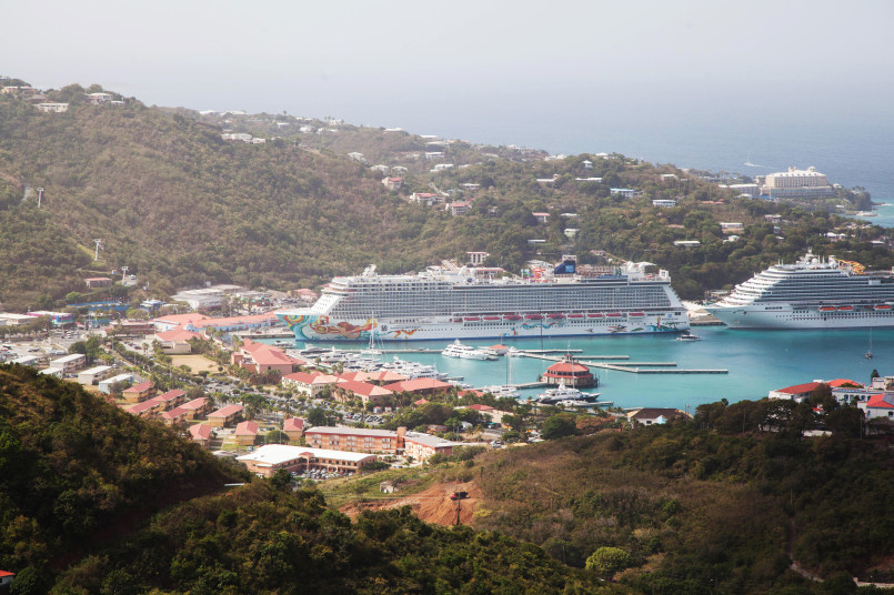 Busy harbor in St. Thomas with cruise ships and colorful buildings