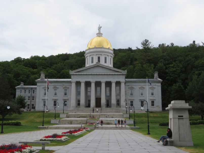 The gold-domed Vermont State House surrounded by fall foliage