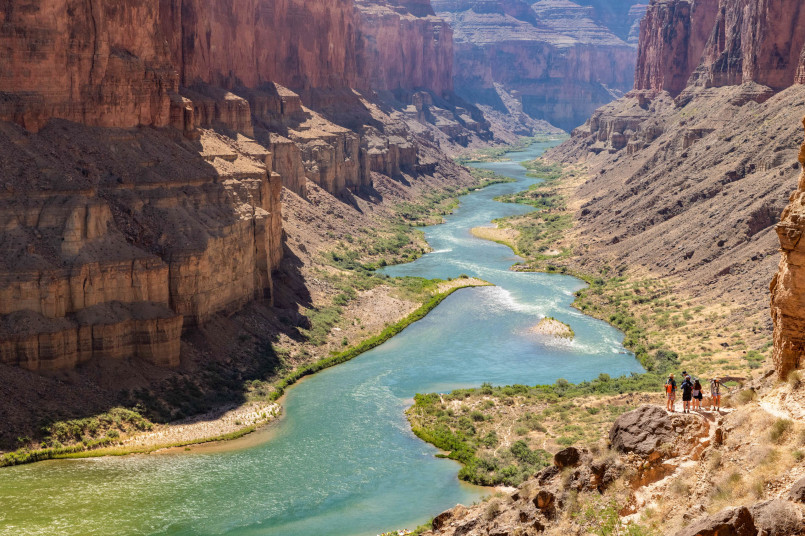 View of the Colorado River winding through the Grand Canyon's immense colorful rock formations