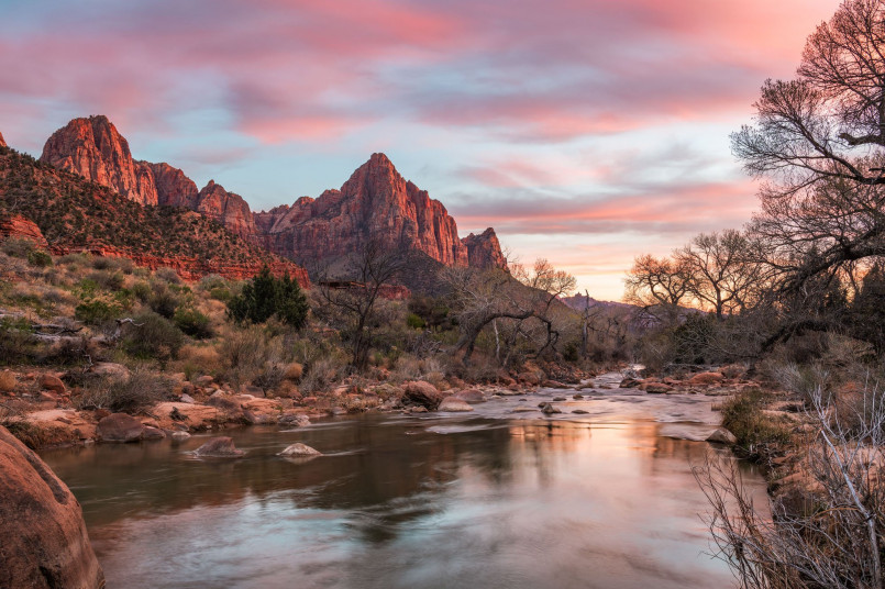 Virgin River flowing through Zion Canyon with massive red sandstone cliffs rising on both sides