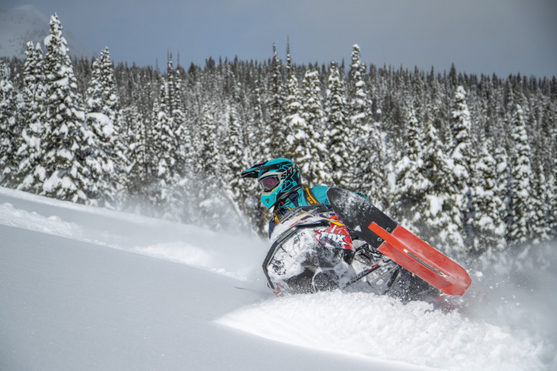 West Yellowstone Montana winter snowmobiles Snowmobiles lined up on a snow-covered street in West Yellowstone with log cabin buildings