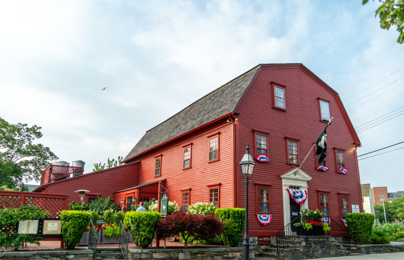 White Horse Tavern's colonial-era white clapboard exterior with red door