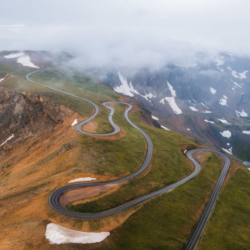 Winding Beartooth Highway with snow-capped peaks in the background