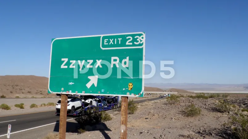 Zzyzx road sign California desert Road sign for Zzyzx, California with barren desert landscape in background